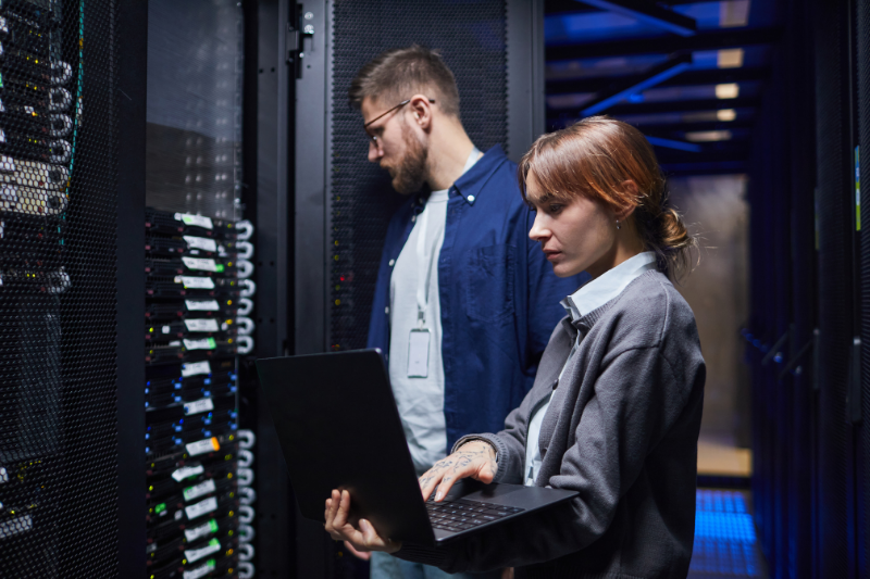 Server rack with colorful fiber optic cables connected to ports.
