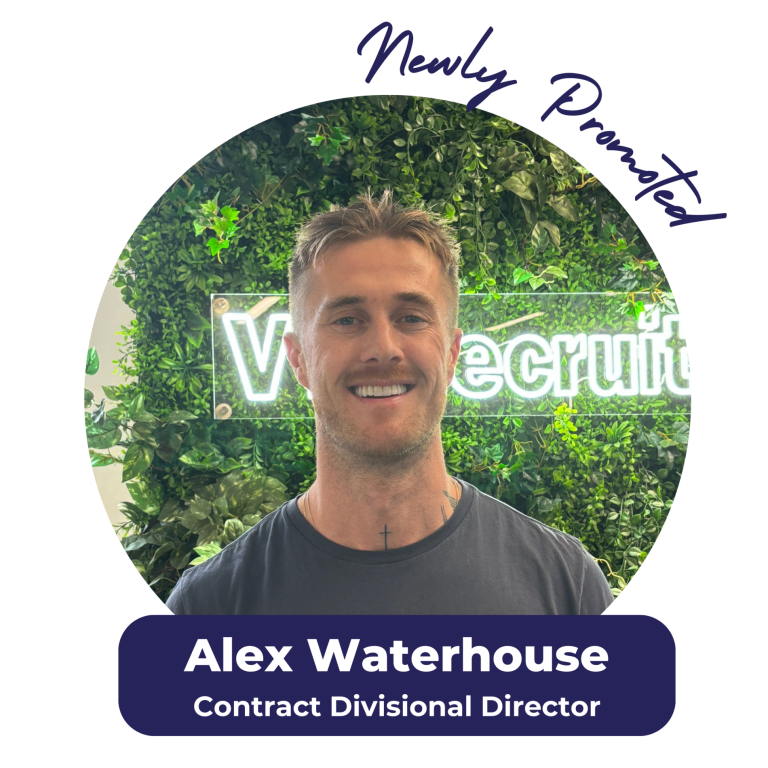 Alex Waterhouse, smiling, newly promoted Contract Divisional Director. Set against a green wall with neon logo.