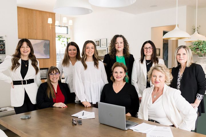 A group of women standing around a table for mtc meridian title corporation