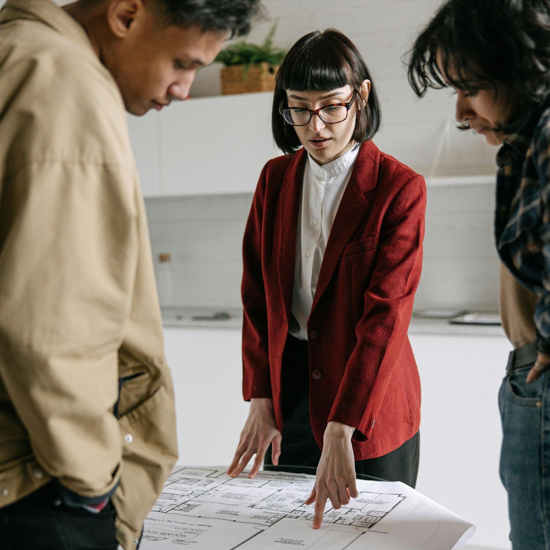 A group of people are standing around a table looking at a piece of paper.