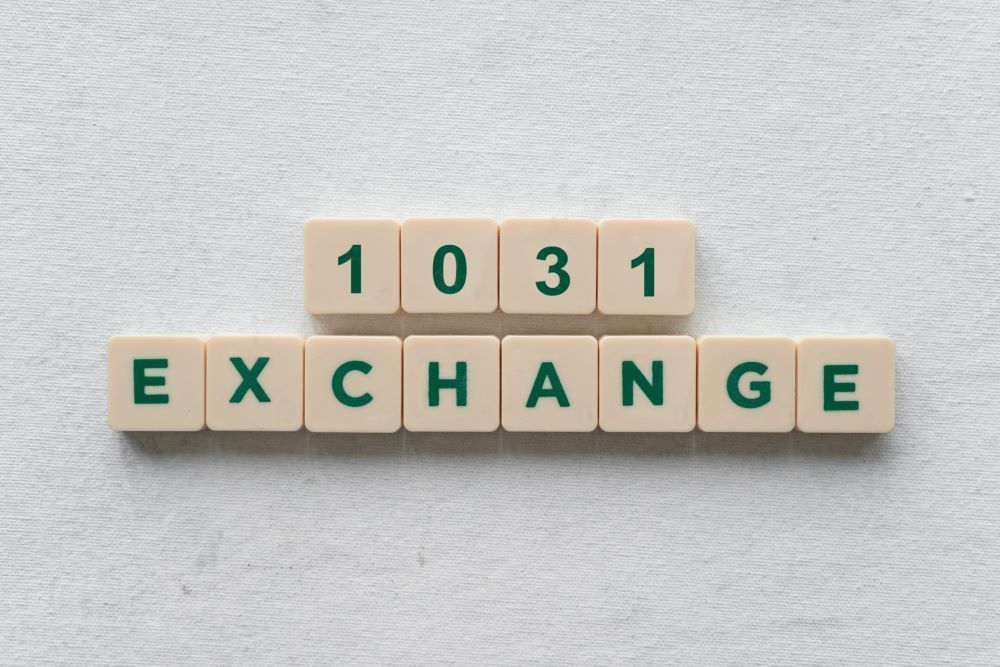The word exchange is written in scrabble tiles on a white surface.