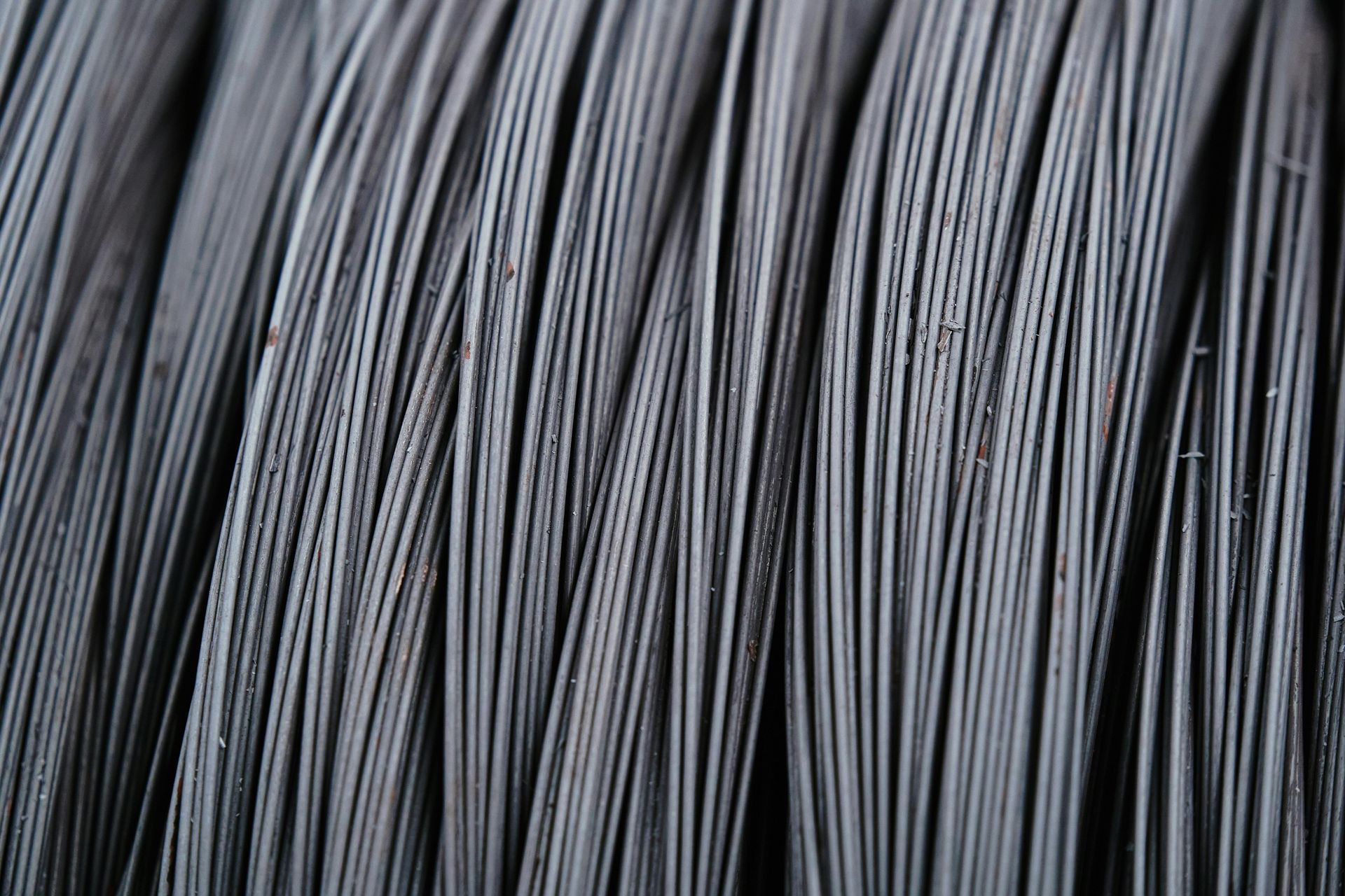 Close-up of tightly bundled gray-black wires or fibers with a striped texture