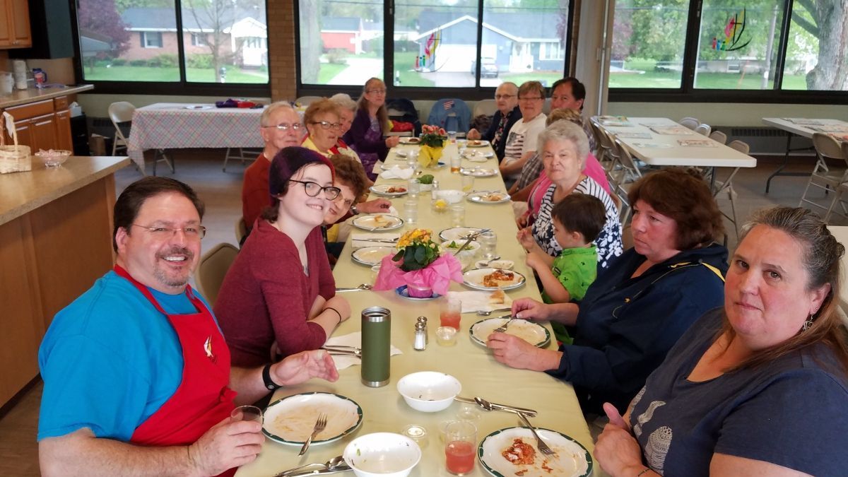 Food and Fellowship 7/11/2019
Group of people seated at a long dining table, smiling during a meal in a bright room