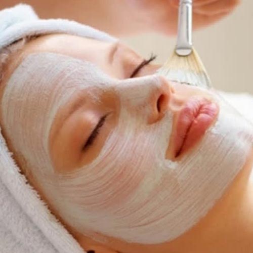 mellow woman with moisturiser on face