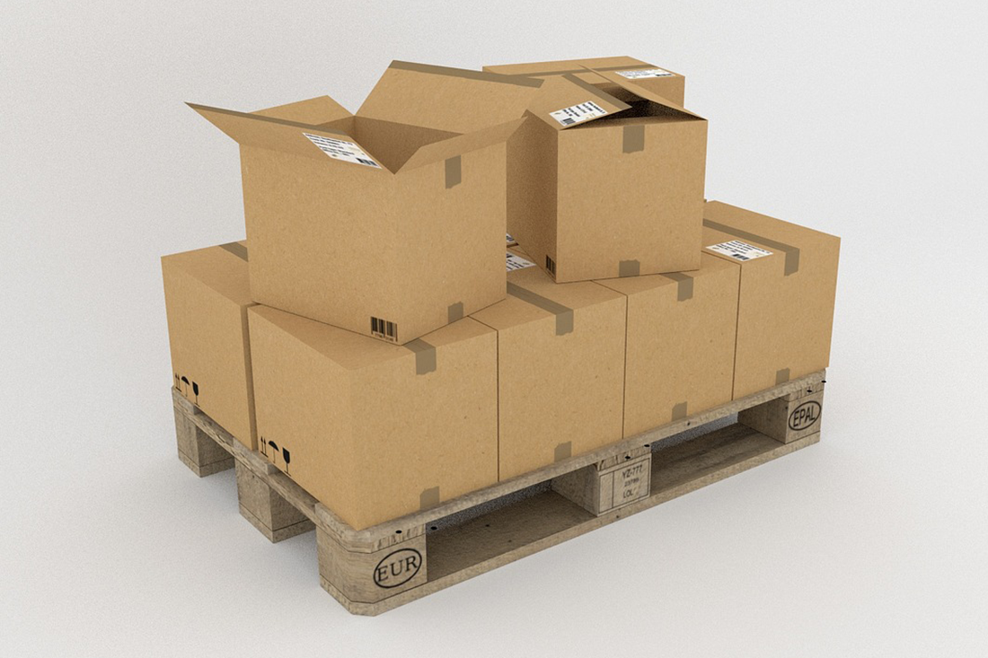 Cardboard boxes stacked on a wooden pallet, ready for shipping.