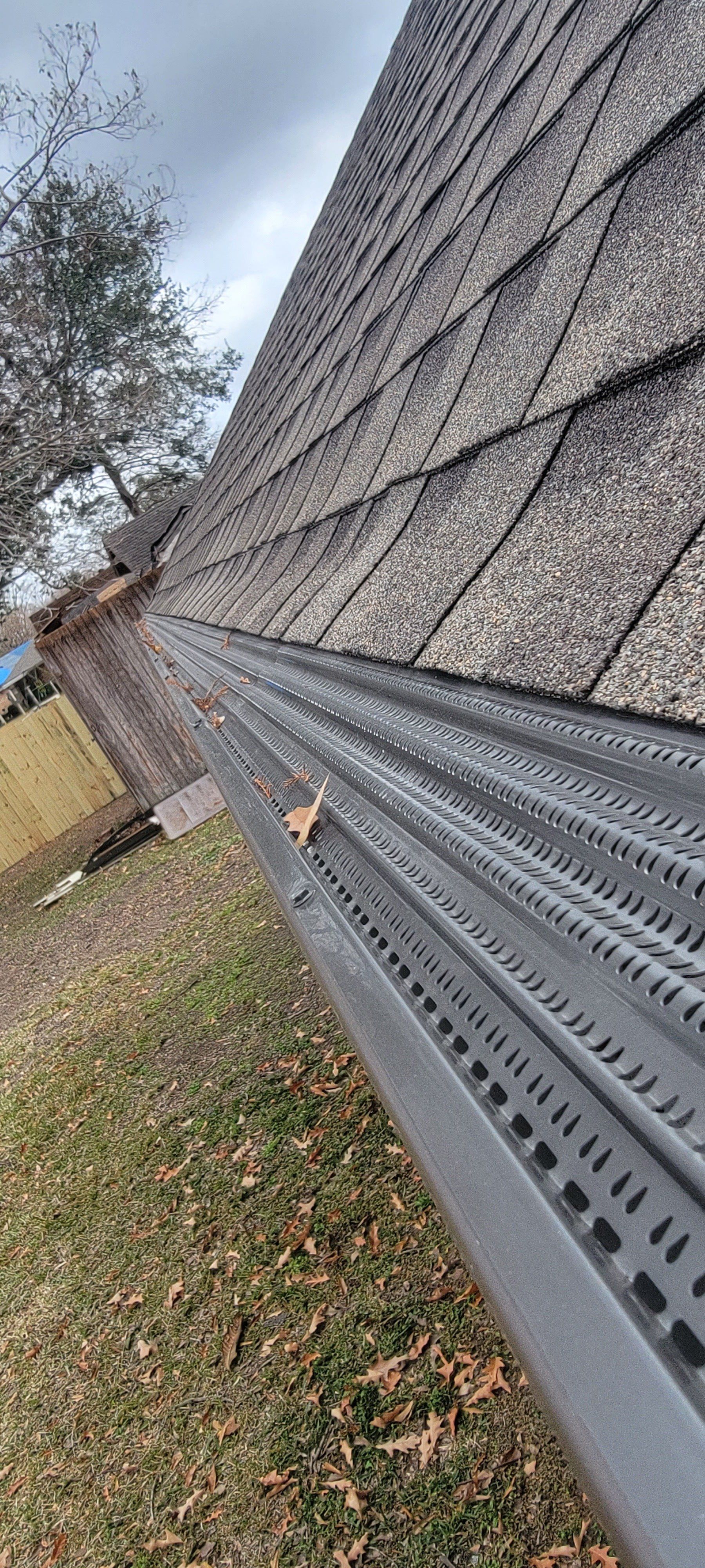 A close up of a gutter on the side of a roof.