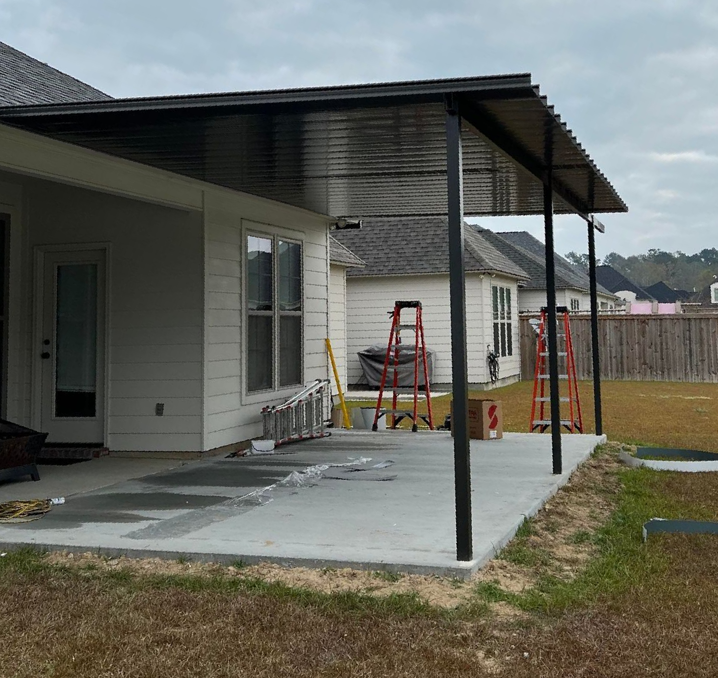 A house with a covered patio in front of it