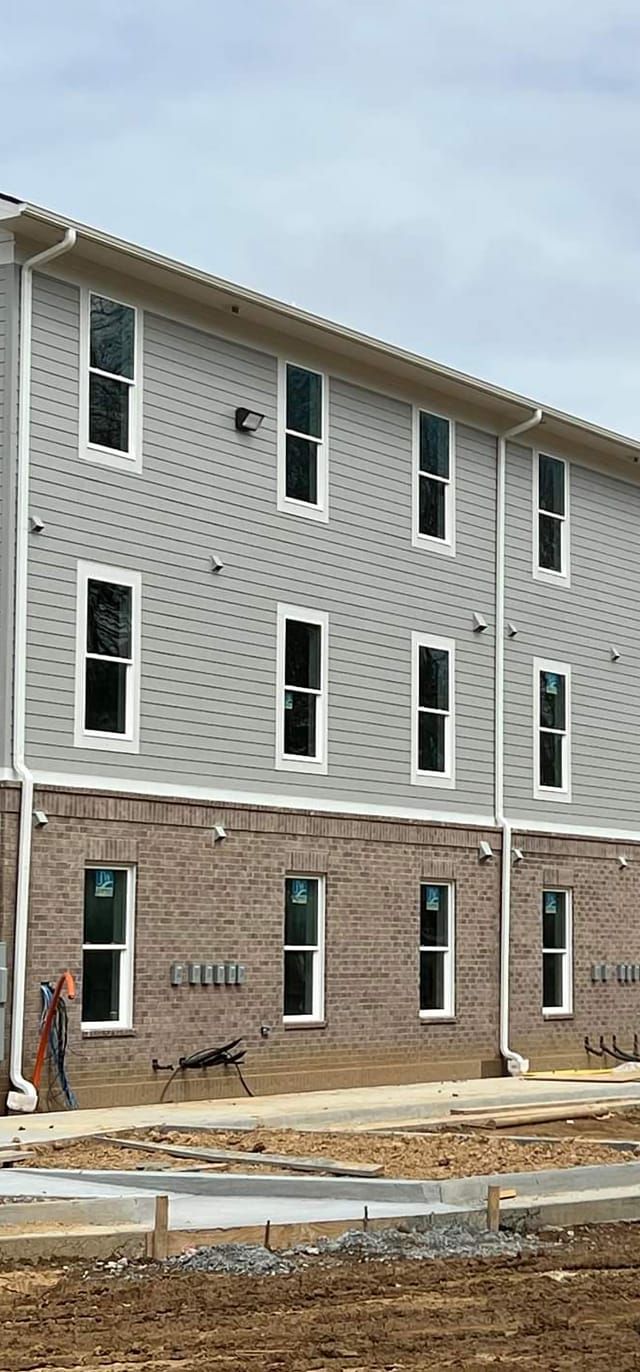 A large brick building with a lot of windows is being built.