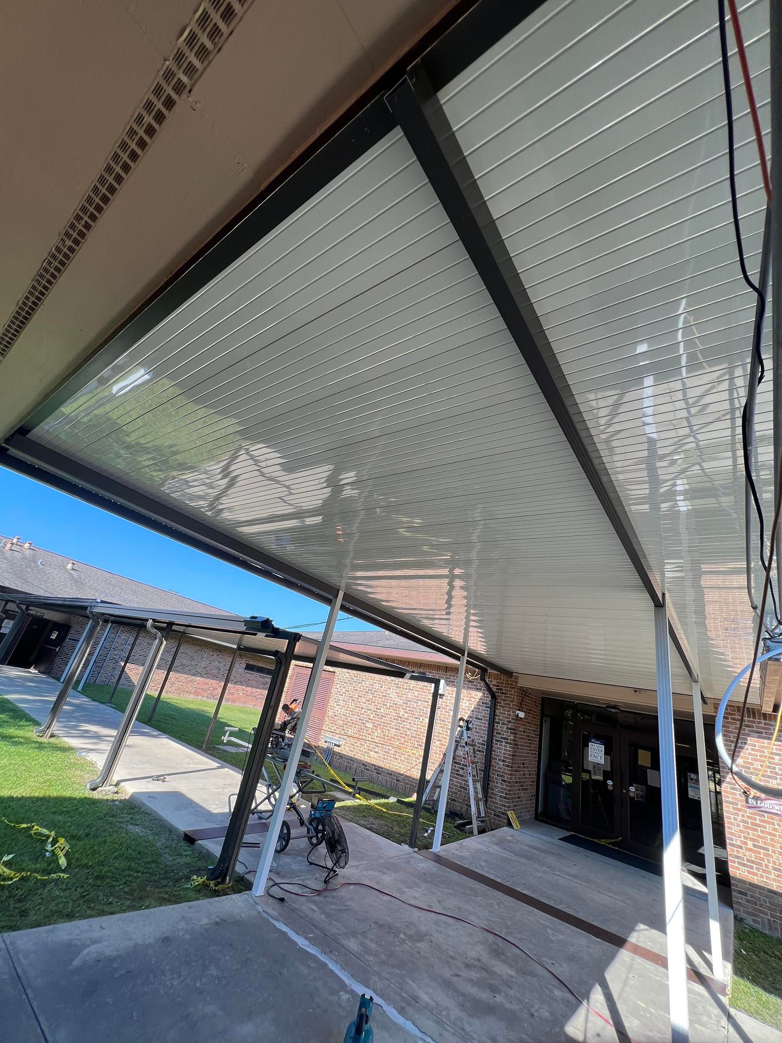 A covered porch with a ceiling that looks like a ceiling of a building.