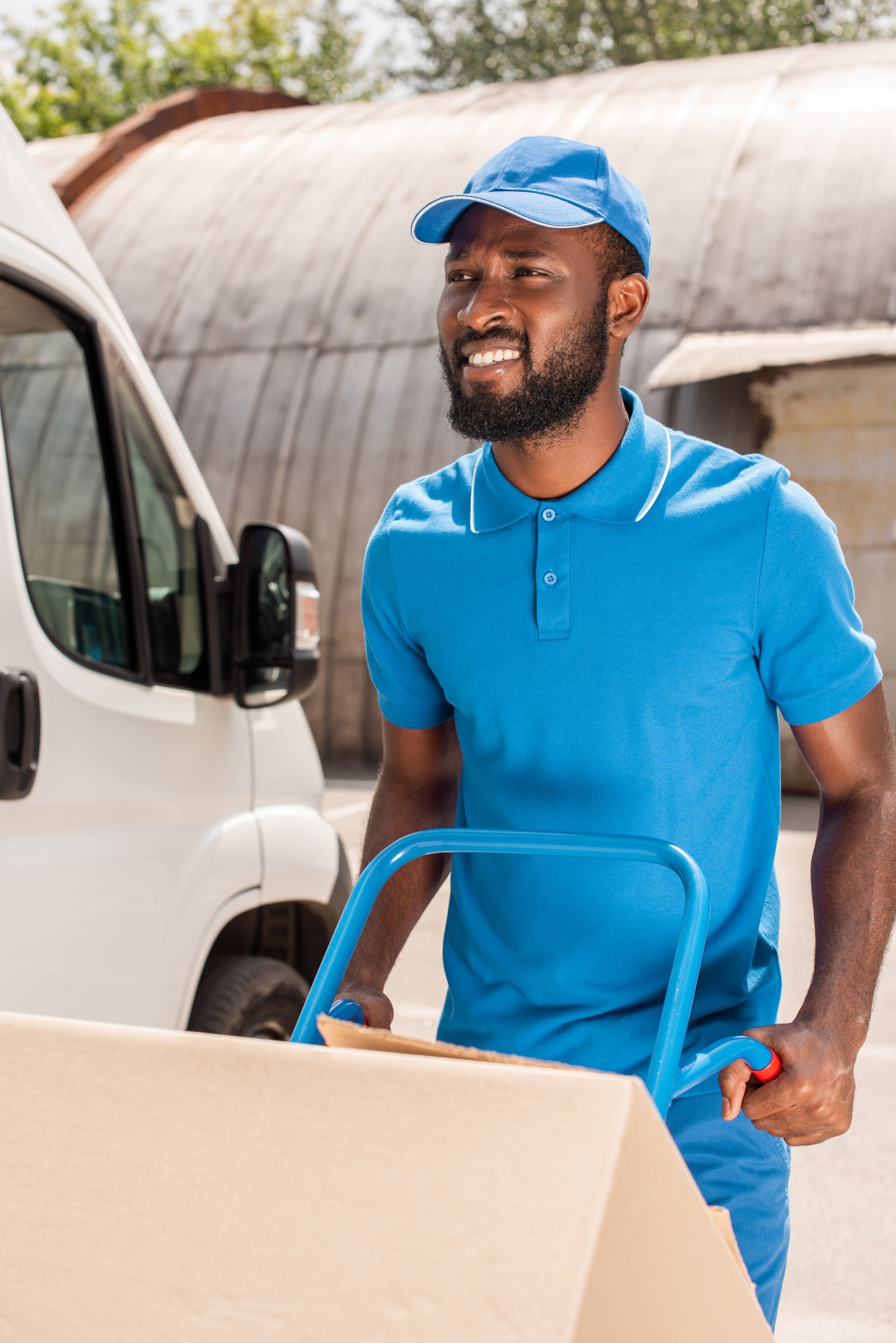 amazon delivery driver with packages on cart