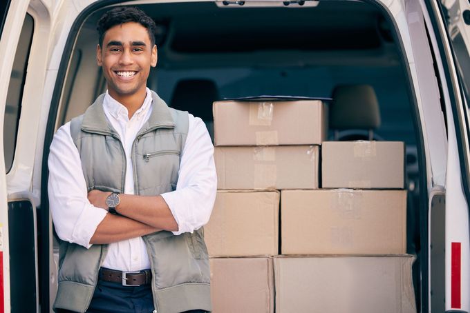 amazon delivery driver with lots of packages 