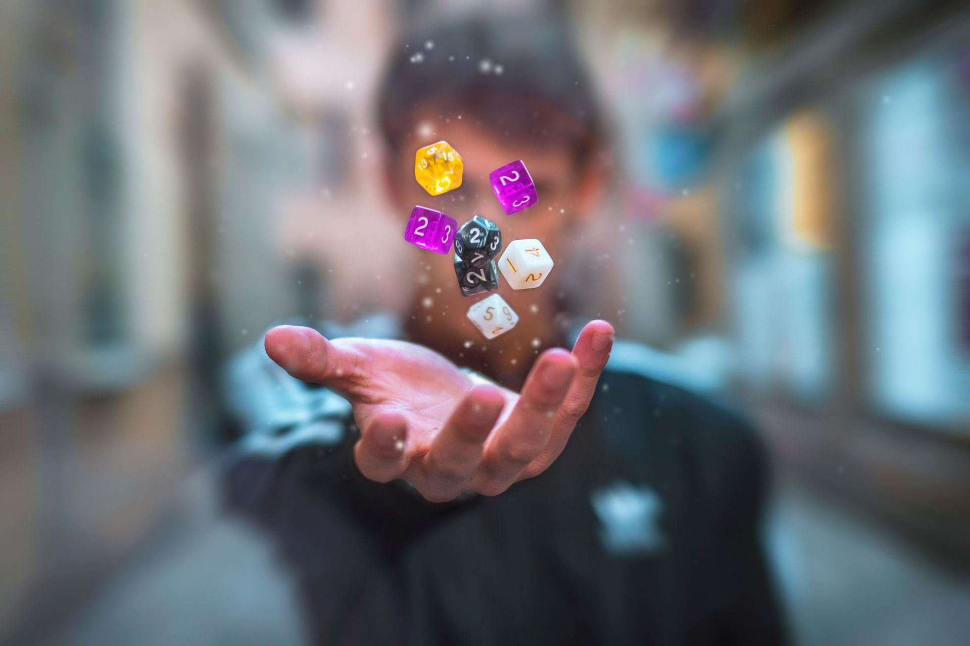 Person with outstretched hand as glowing dice float above it in a blurred street scene