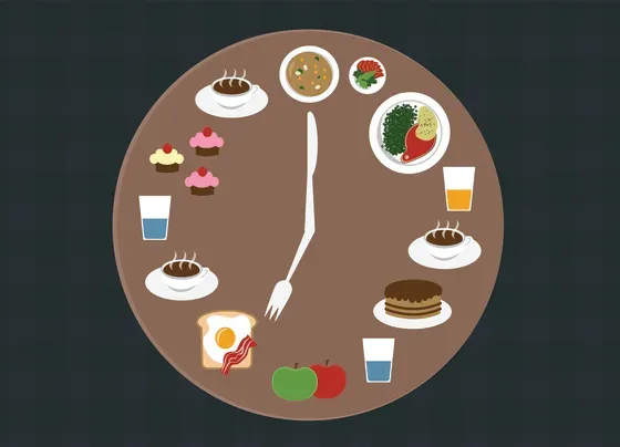 Multiple food items surround a circle, forming what looks like a clock, and a knife and fork act as the hands