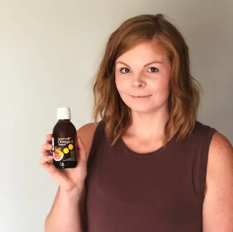 A person holds up a bottle