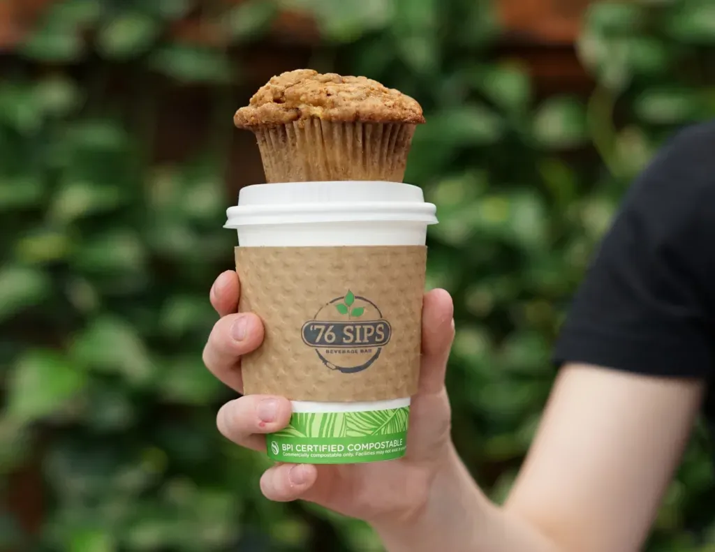 A Apple Cinnamon Crumb Muffin sitting on a coffee cup for 76 Sips