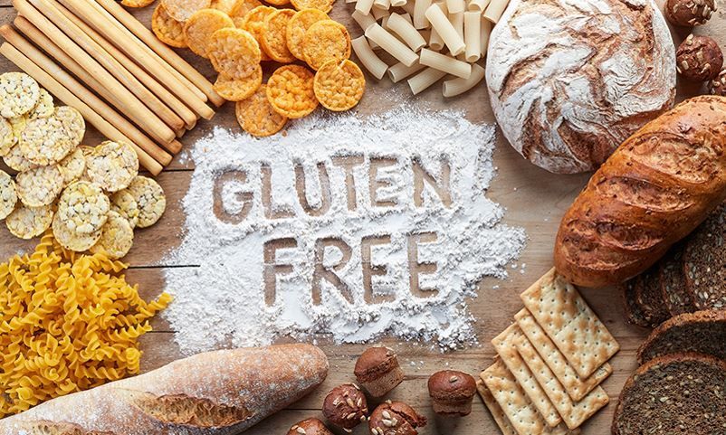 Various food items sit on the table surrounded by flour in the middle with the words
