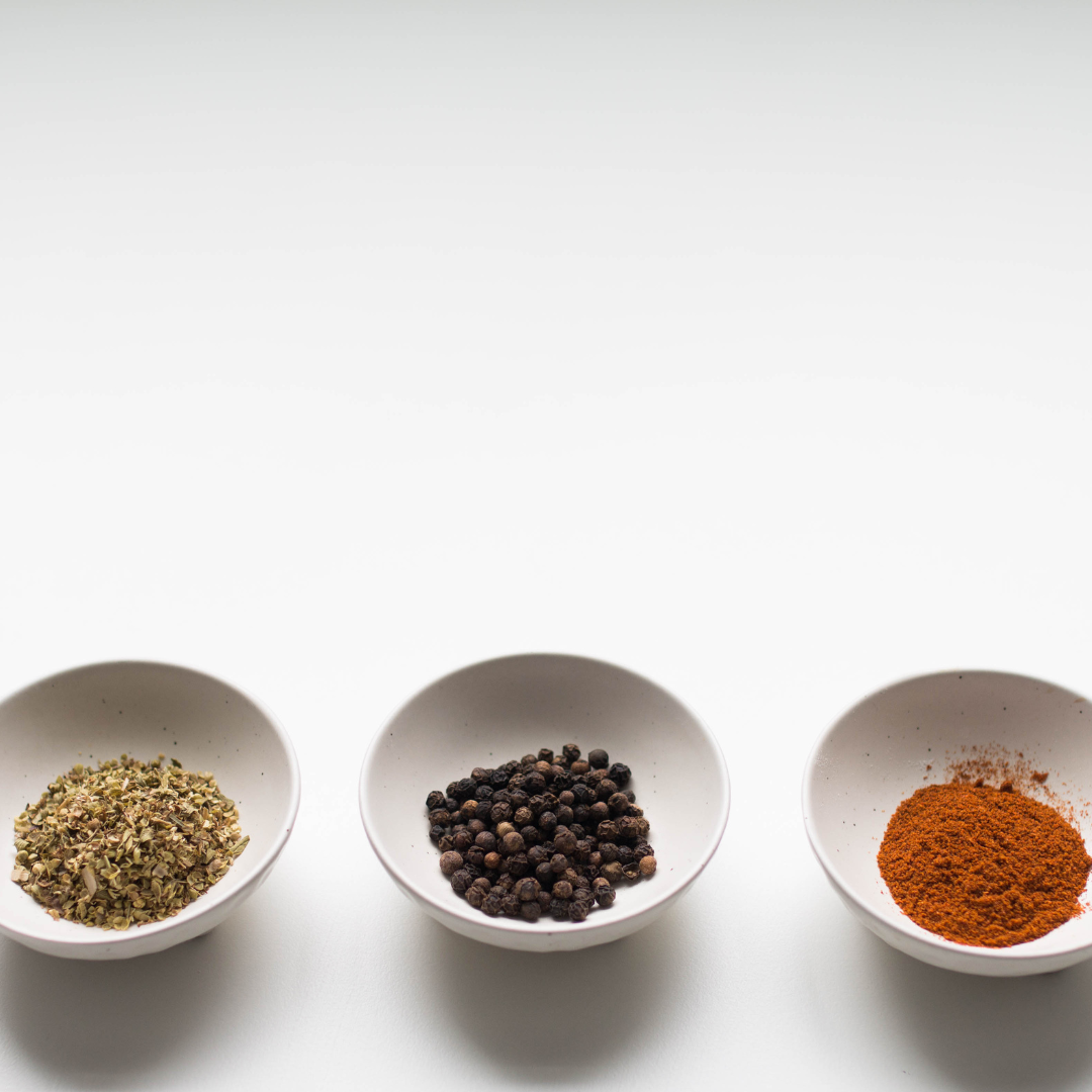 Small white bowls with various spices in them