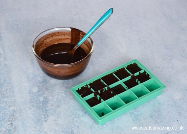 putting melted chocolate in silicone tray