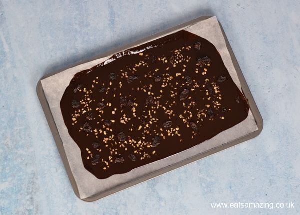 nuts added to chocolate on parchment paper