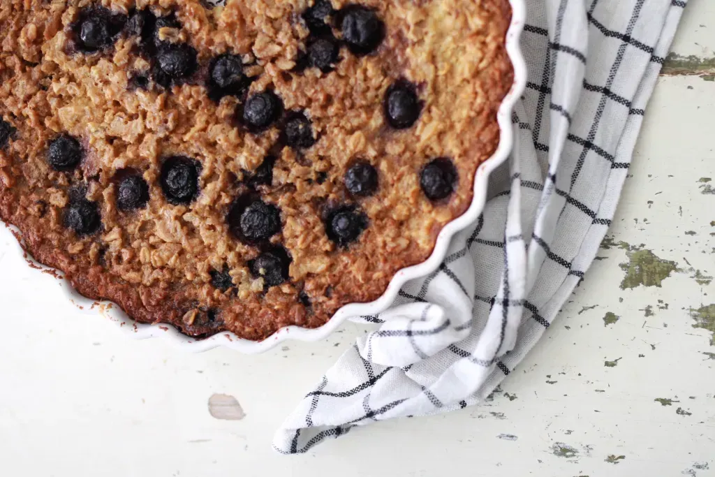 breakfast oatmeal bake in pan next to a tea towel
