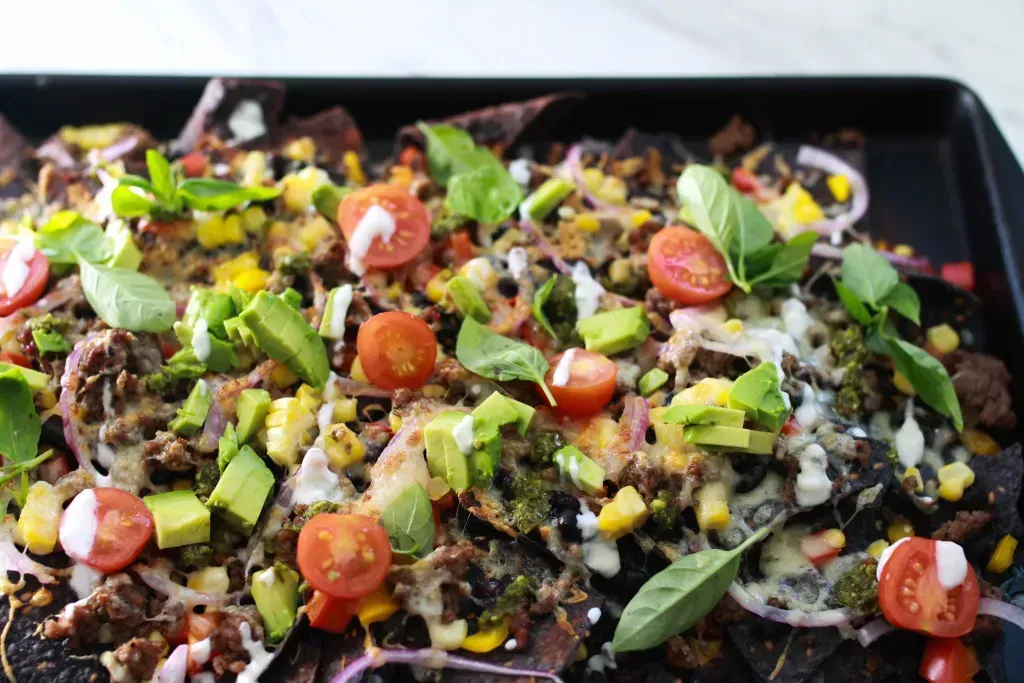 Loaded nachos with tomatoes, green onion and ground beef