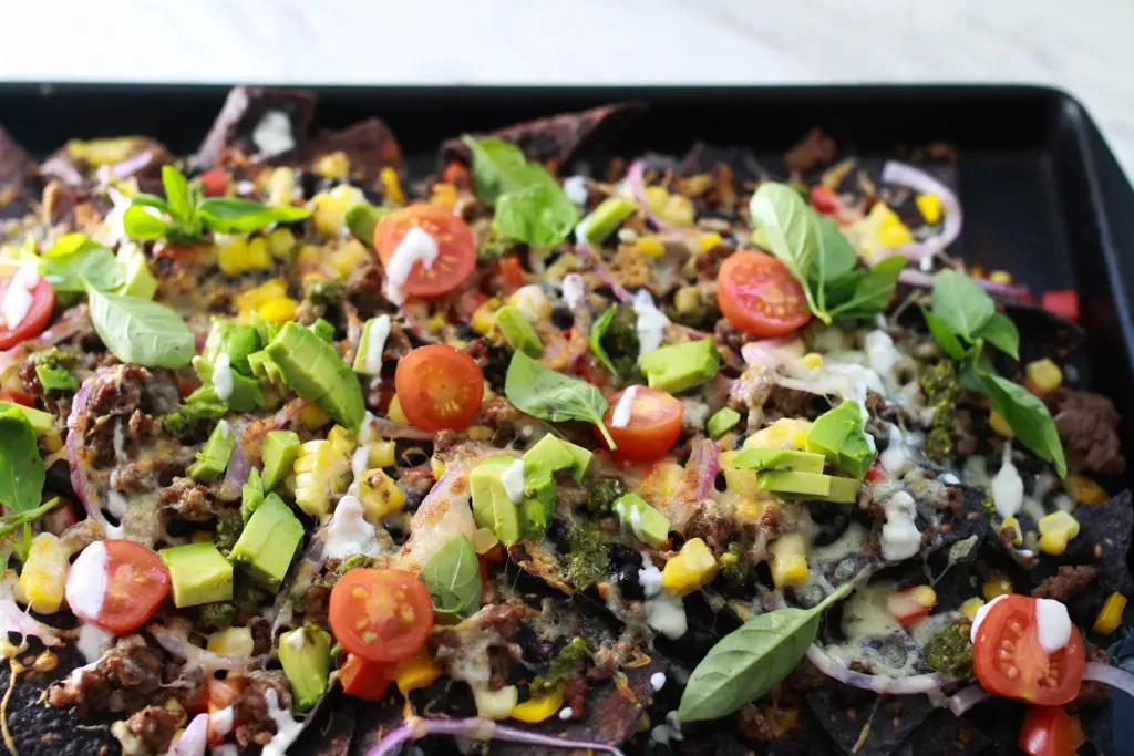Loaded nachos with tomato, lettuce, green onion and ground beef