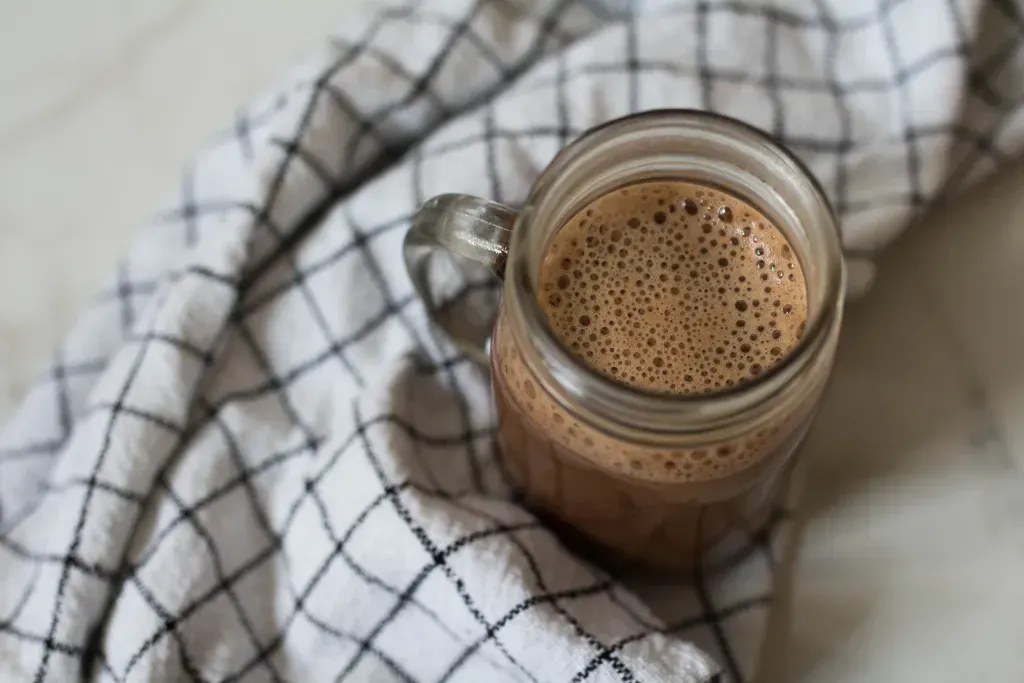 A glass mug of chocolate milk
