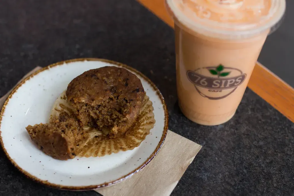 Sunrise muffin on a plate next to a smoothie