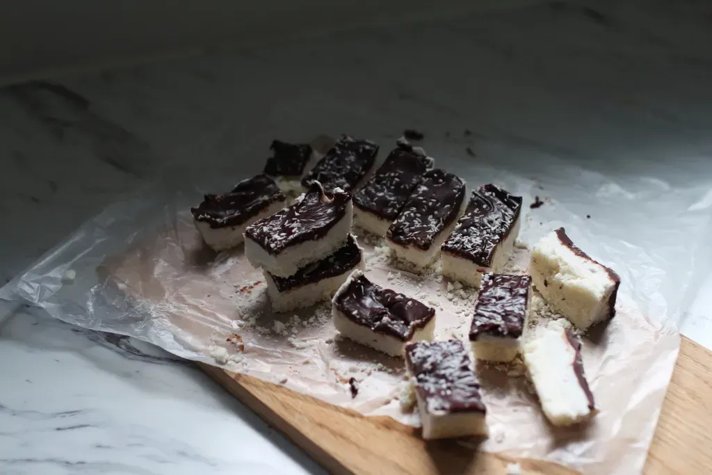 Holiday treats sitting on parchment paper on a cutting board