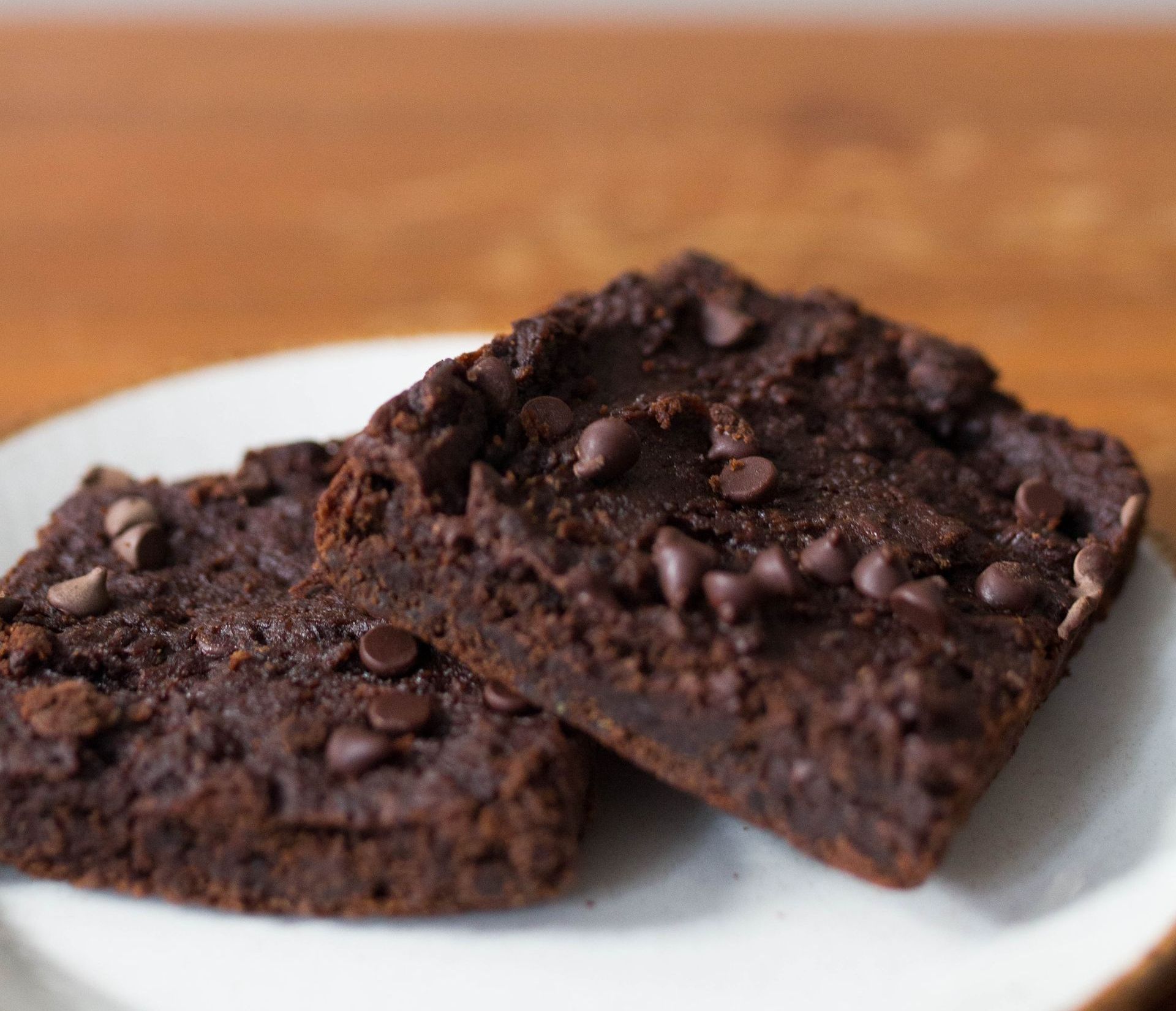 Freshly baked chocolate brownies sitting on a plate