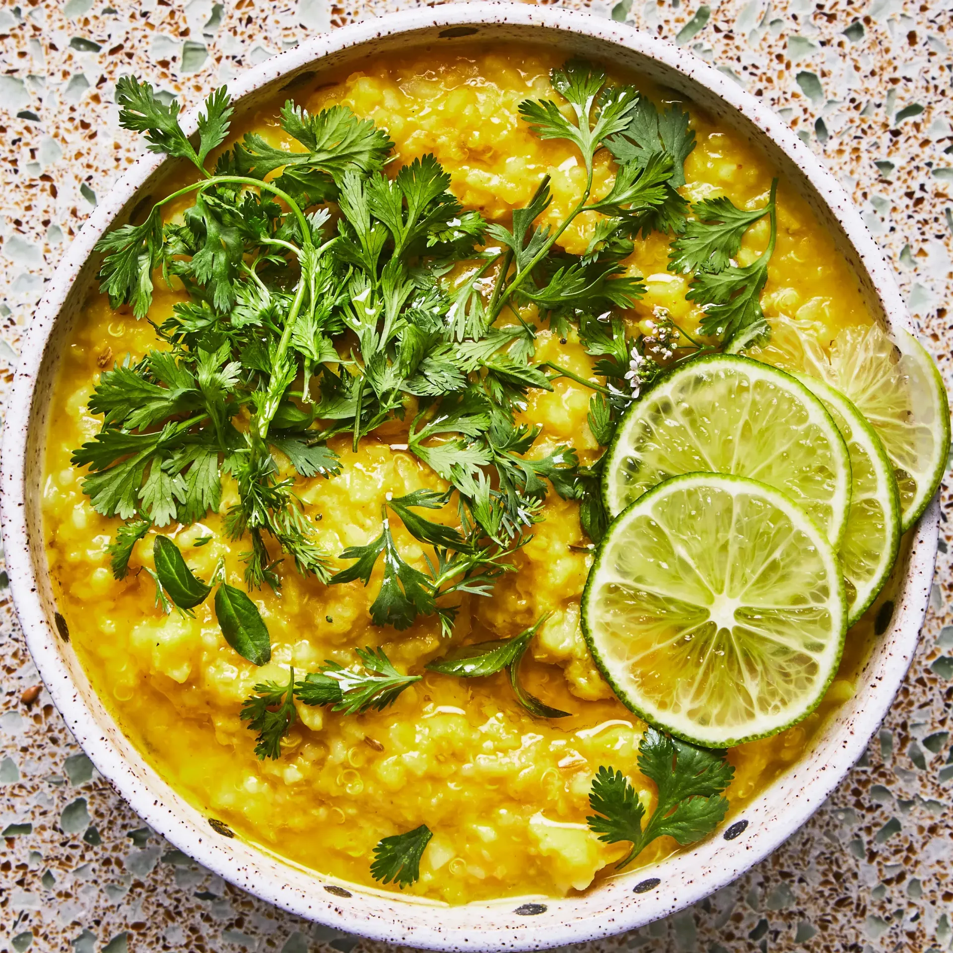 A dish of yellow rice with fruits and veggies