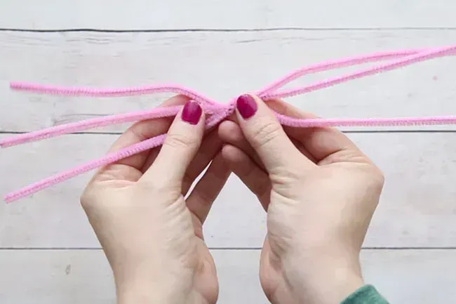 A person tying piper cleaners