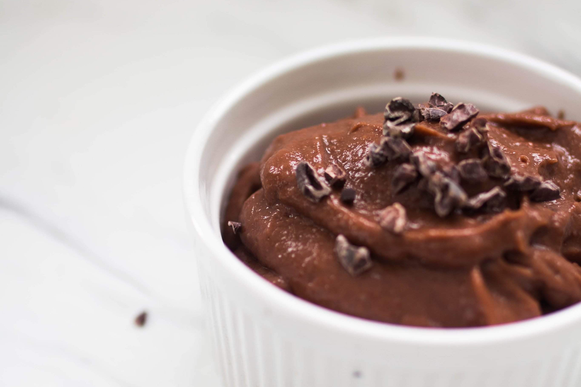 A close up look at a cup of chocolate pudding