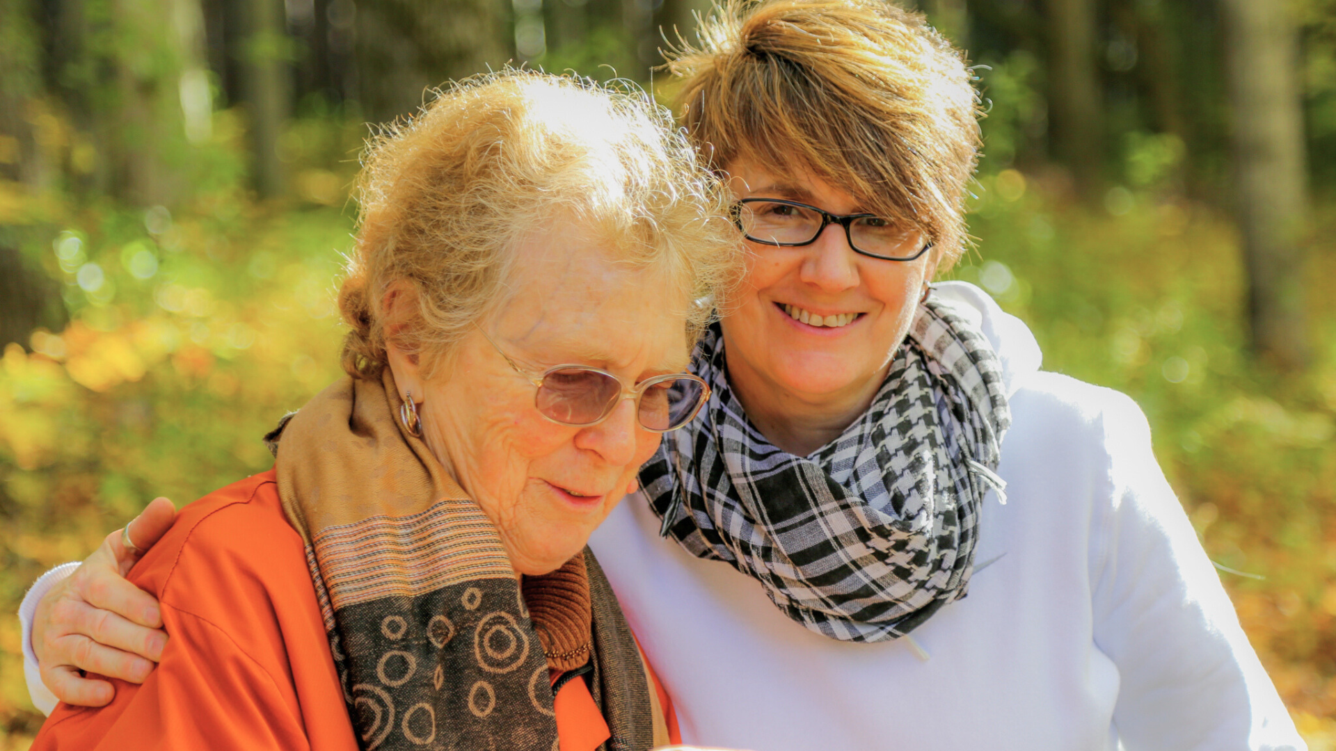 Jo Anne and Margo sit outside with their arms around each other