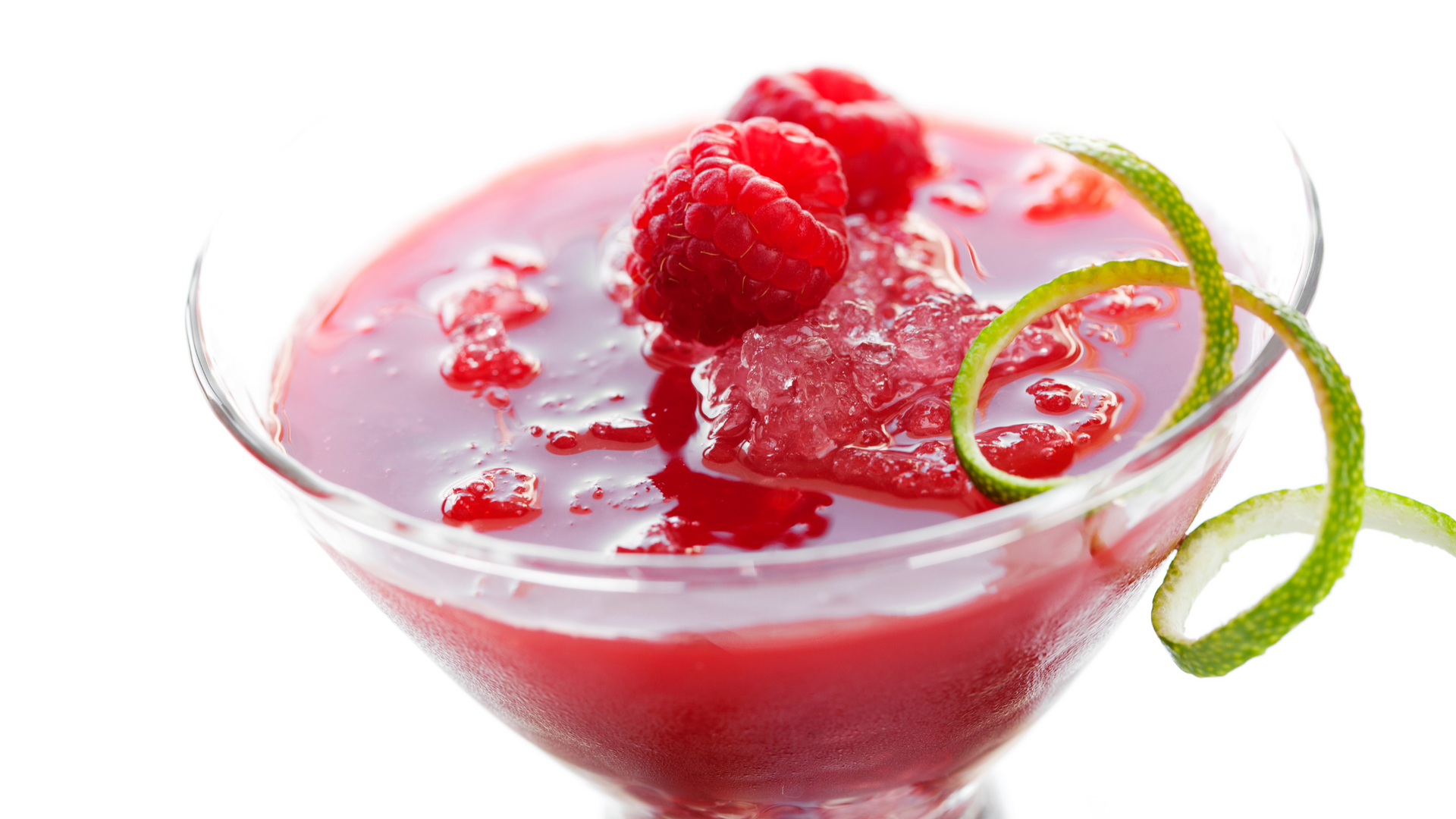 A red drink sits in a martini glass