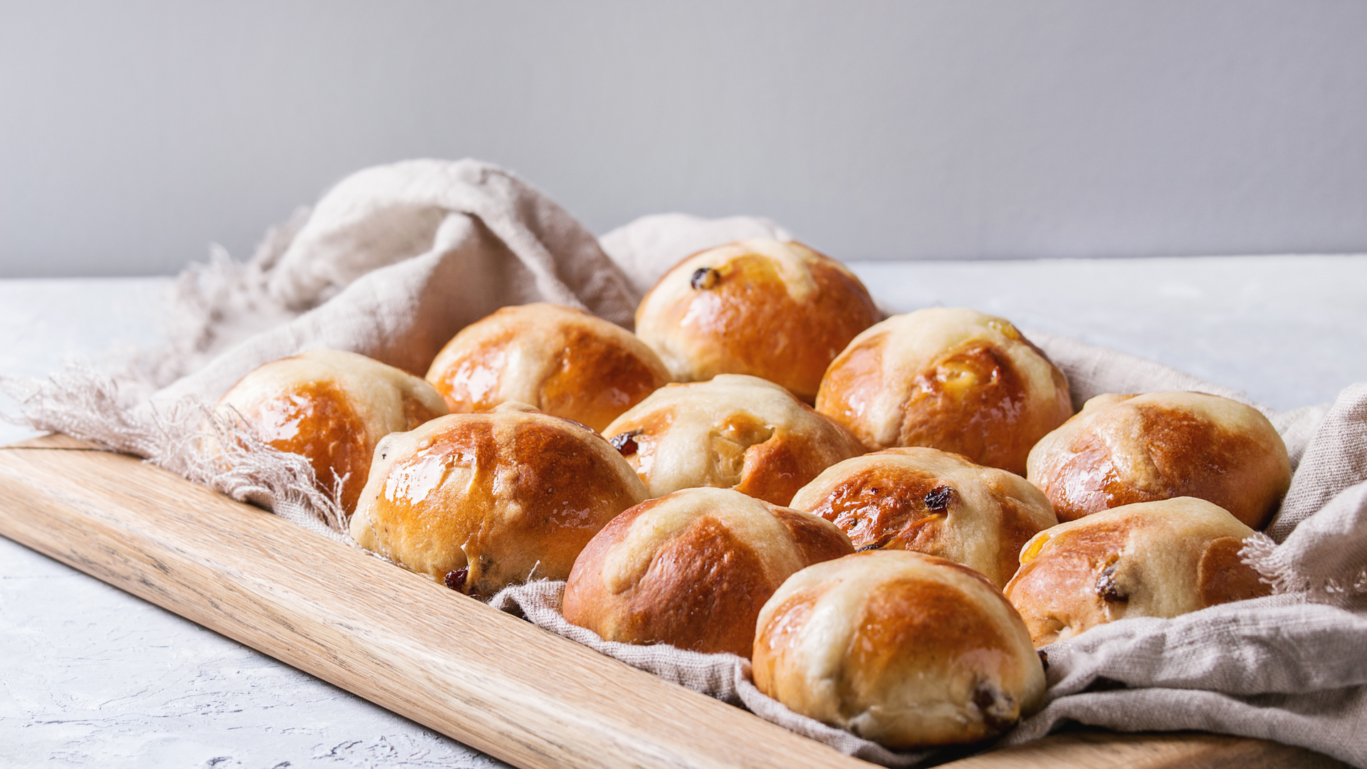 Freshly baked buns sit on a towel