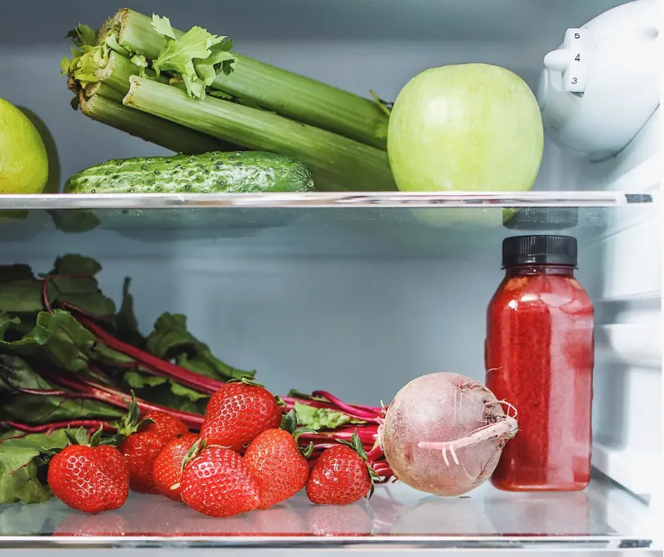 Several produce items sit in a freezer