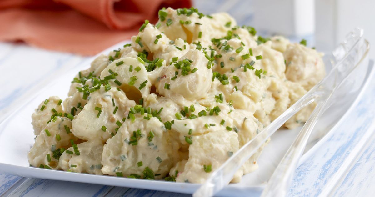A creamy potato salad sits on a plate