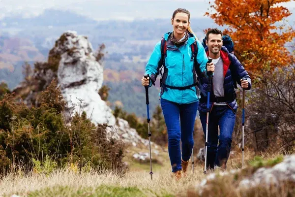 man and woman hiking a mountain