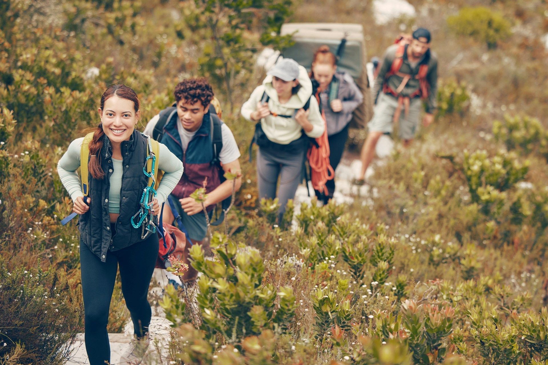 A group of people hike on a trail