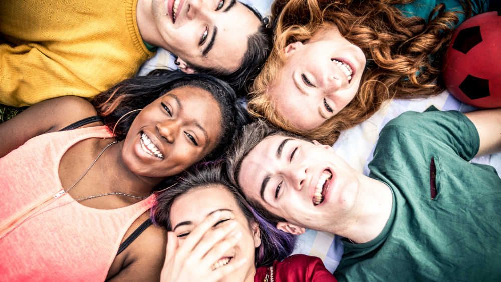 Kids laying down in a circle laughing