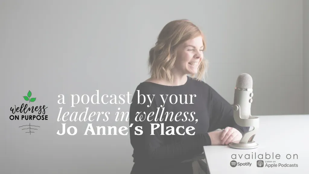 Marissa Laughlin, podcast host, sits at a table with a microphone