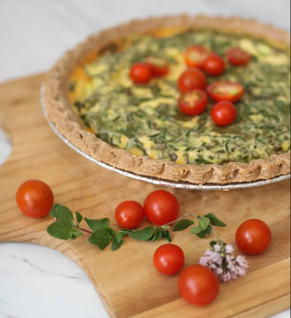 Tomatoes lie on top of a quiche