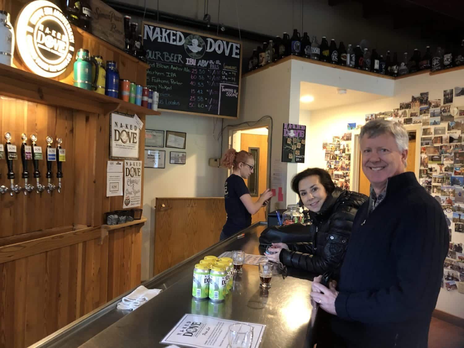 couple sitting together at the bar in brewery