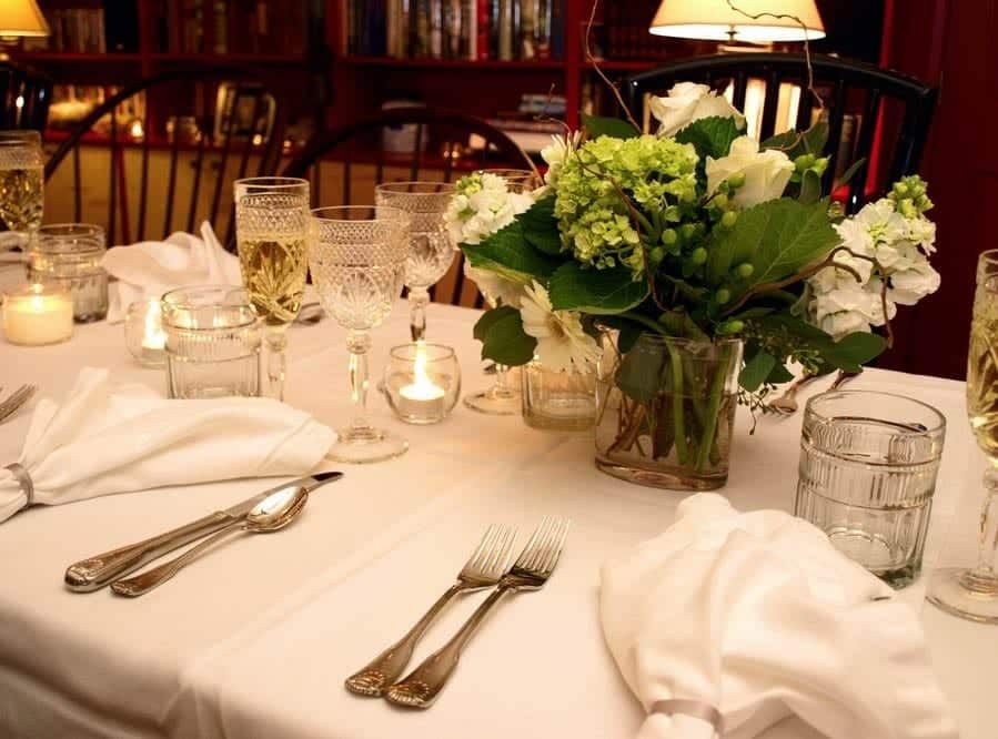 A table with a vase of flowers on it