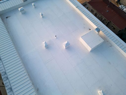 Handyman using nail gun to install shingle to repair roof