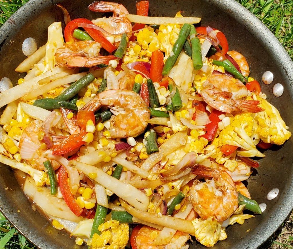 A pan filled with shrimp corn and green beans