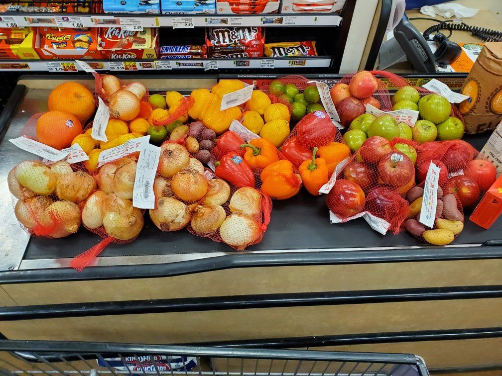 A variety of fruits and vegetables are on display in a grocery store