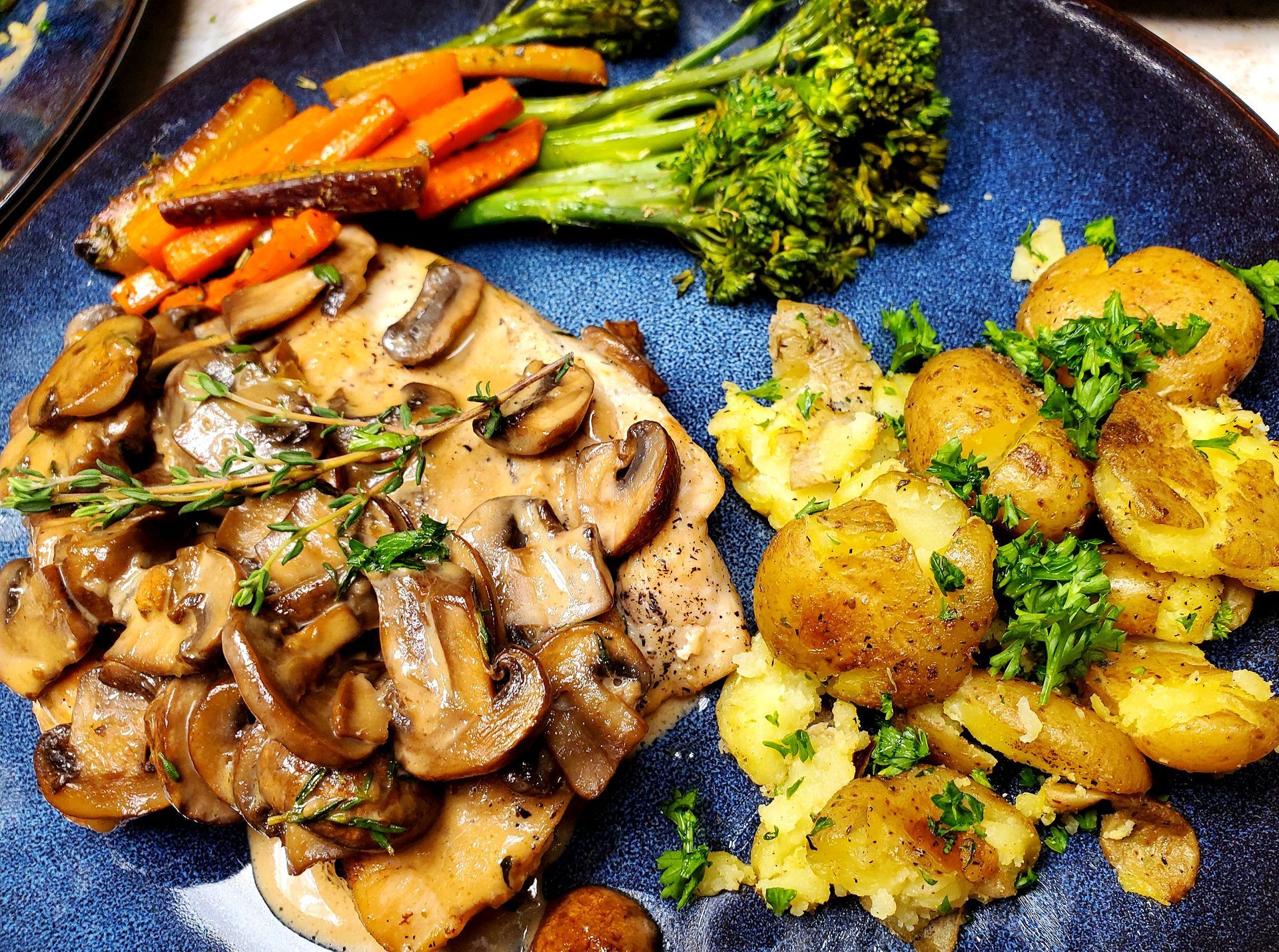 A plate of food with mushrooms carrots broccoli and potatoes