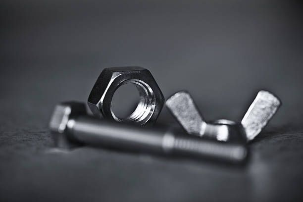 A close up of nuts and bolts on a table.
